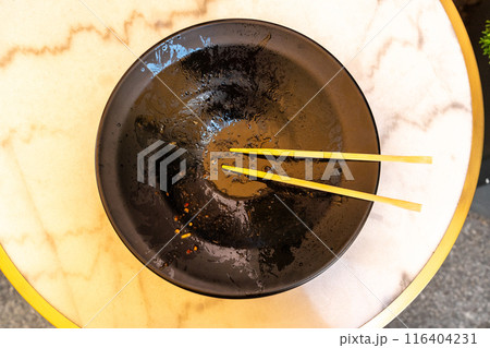 Udon Leftovers, Finished Meal on Dirty Plate, Black Bowl after Dinner, Greasy Oily Lunch Smeared Sauce Udon Leftovers, Finished Meal on Dirty Plate, Black Bowl after Dinner, Greasy Oily Lunch Smeared Sauce 116404231