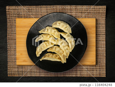 Gyoza Chinese Dumplings Top View, Vegetable Jiaozi, Chicken Momo Pile, Asian Gyoza Portion on Black 116404248
