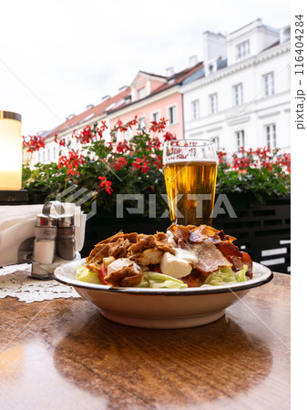 Polish Caesar salad with chicken, bacon and vegetables, high-calorie meat salad with fresh vegetables Polish Caesar salad with chicken, bacon and vegetables, high-calorie meat salad with fresh vegetables 116404284