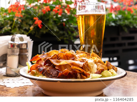 Polish Caesar salad with chicken, bacon and vegetables, high-calorie meat salad with fresh vegetables 116404285