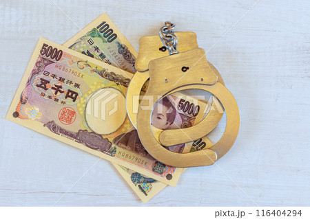 An economic crime associated with corruption illegal profits using Japanese yen is handcuff placed by police 116404294