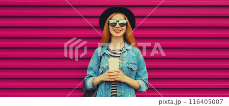 Portrait stylish happy young woman with coffee, modern girl in hat, glasses on pink background 116405007