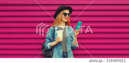Stylish modern young woman with phone, happy girl smiles using smartphone with cup of coffee Stylish modern young woman with phone, happy girl smiles using smartphone with cup of coffee 116405021