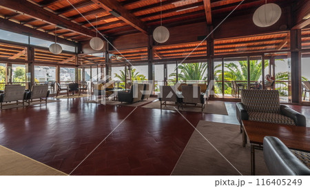 Panorama showing Interior of a modern hotel cafe bar restaurant with piano and fireplace timelapse 116405249