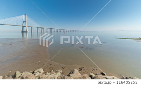 Motion from the low to high tide next to Vasco da Gama Bridge in Parque das Nacoes timelapse in Lisbon, Portugal. 116405255