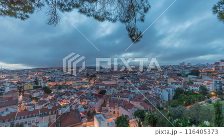 Panorama showing aerial cityscape day to night transition from Miradouro da Graca viewing point in Lisbon city after sunset 116405373