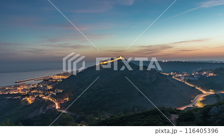 Panorama showing aerial view of Sesimbra Town and Port day to night timelapse, Portugal. Panorama showing aerial view of Sesimbra Town and Port day to night timelapse, Portugal. 116405396