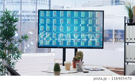 Big screen in financial department office shows stock exchange indices changing in real time. Display in empty workplace with trading indexes showing latest price modifications, camera B 116405470