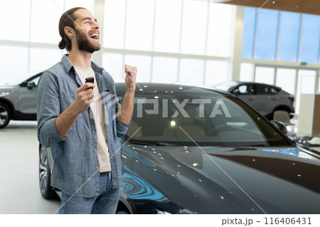Confident young man in casual clothes near the car 116406431