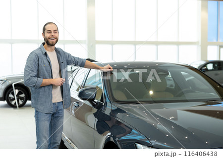Confident young man in casual clothes near the car 116406438