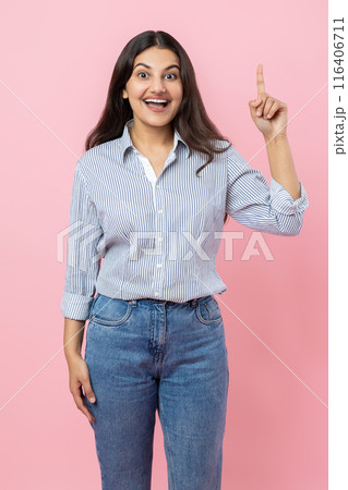 Excited amazed Indian woman indicating upwards having idea Excited amazed Indian woman indicating upwards having idea 116406711