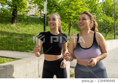 Body positive plus-size plump woman athlete jogging in fitness outfit 116406848