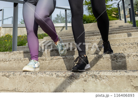 Unrecognizable women running on stairs during sunny morning on stadium Unrecognizable women running on stairs during sunny morning on stadium 116406893