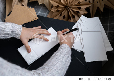 Sustainableminded Christmas cozy home handmade decoration. Tutorial for making do it yourself craft paper lunch bags and hot glue. Seasonal activity for kids. 3D snowflakes eve preparation 116407536