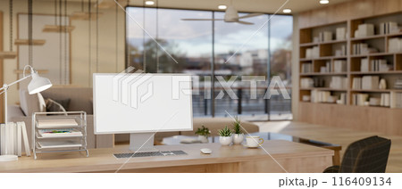 A computer mockup on a wooden desk in a contemporary spacious living room or private office. A computer mockup on a wooden desk in a contemporary spacious living room or private office. 116409134