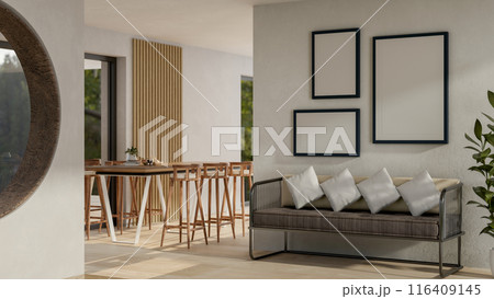 The interior design of a modern spacious indoor corridor with a sofa, a table with stools, and decor 116409145