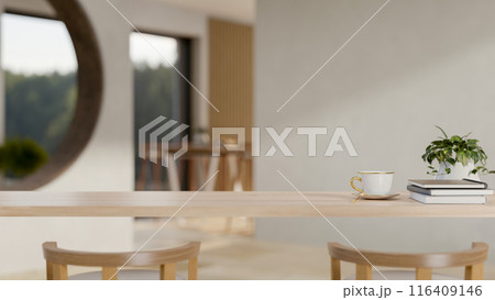 A wooden table in a cozy contemporary room with decor and a copy space for display products. 116409146