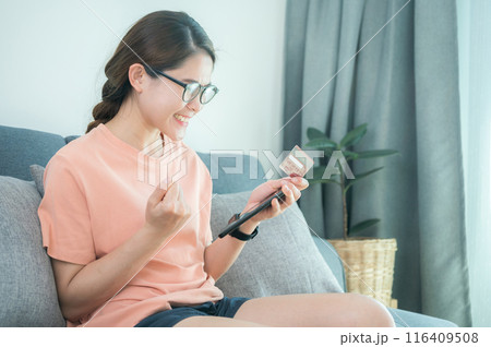 Asian woman having feels good after buying somethings online by credit card. 116409508