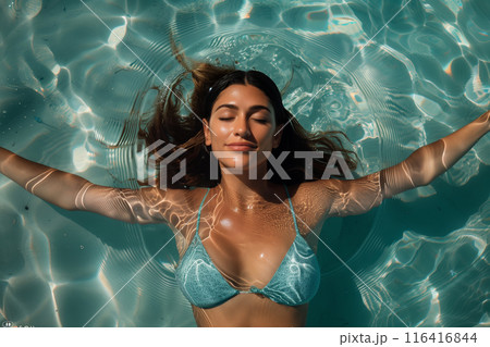 Woman In Blue Bikini Relaxing In Turquoise Water On Sunny Day 116416844
