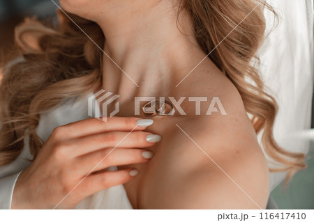 without a face. wedding rings on the bride's collarbone.  116417410