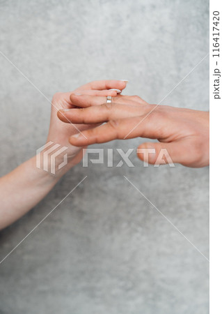 The hands of a man and a woman exchange wedding rings. The hands of a man and a woman exchange wedding rings. 116417420