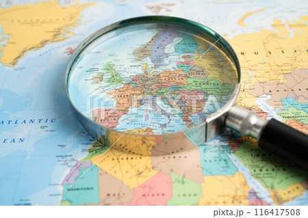 Bangkok, Thailand - June 15, 2024 Europe, Magnifying glass close up with colorful world map, travel, geography, tourism and exploration concept. 116417508