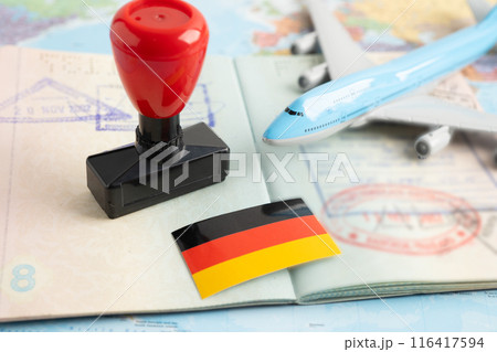 Germany flag with approved Stamp visa and passport document to immigration at airport in country. 116417594