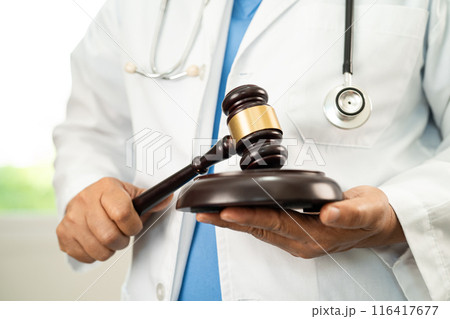 Doctor holding judge gavel, medical law and crime justice. Doctor holding judge gavel, medical law and crime justice. 116417677