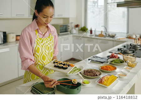 Housewife Putting Kimbap In Lunchbox Housewife Putting Kimbap In Lunchbox 116418812