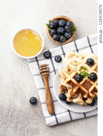 Waffles with blueberries on tables 116419078