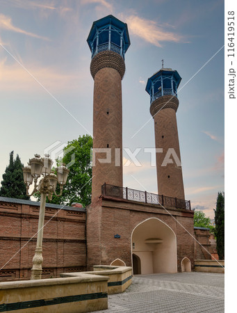 Juma Mosque of Ganja, Azerbaijan, with its two tall minarets and red bricks facade 116419518
