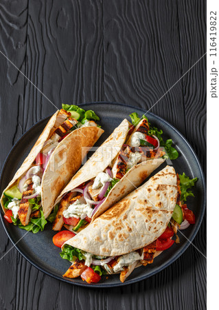 grilled chicken street tacos on a dark plate grilled chicken street tacos on a dark plate 116419822