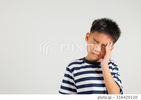 Portrait of Asian young kid boy sad tired strain face holding hold head by hands, stress primary child person unhappy closed eyes problem headache, studio shot isolated on white background Portrait of Asian young kid boy sad tired strain face holding hold head by hands, stress primary child person unhappy closed eyes problem headache, studio shot isolated on white background 116420120