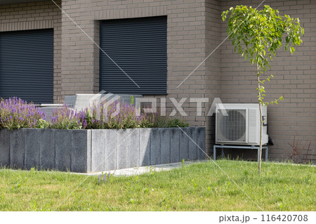 Heat Pump Systems Installed on Modern Brick Building Heat Pump Systems Installed on Modern Brick Building 116420708