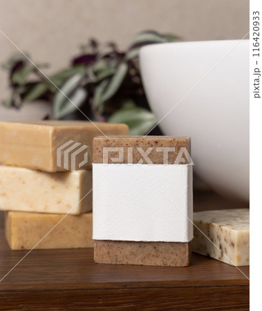 Soap bar with blank label near green plant and vessel basin on wood in bathroom, mockup Soap bar with blank label near green plant and vessel basin on wood in bathroom, mockup 116420933