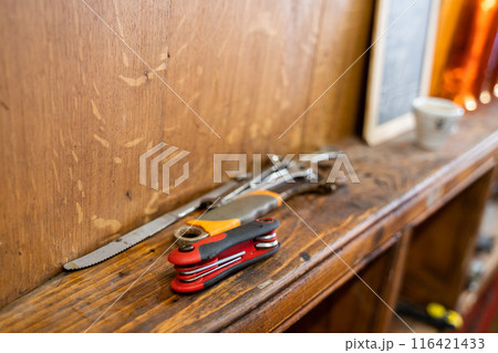 An assortment of tools on a wooden shelf in a wellorganized workshop An assortment of tools on a wooden shelf in a wellorganized workshop 116421433