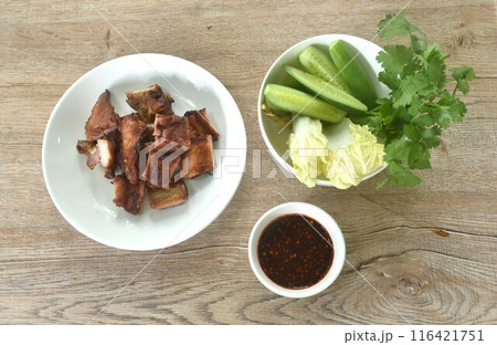gilled slice pork bone on plate with vegetable dipping spicy chili tamarind sauce gilled slice pork bone on plate with vegetable dipping spicy chili tamarind sauce 116421751