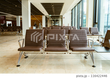 Airport lounge with comfy chairs, windows for travelers to relax before flying 116422446