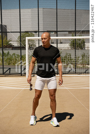 Portrait of sports trainer and handsome athlete man on outdoor sports ground. Close up. Copy space. Outdoors. Workout open air on urban background. Crossfit training. Portrait of sports trainer and handsome athlete man on outdoor sports ground. Close up. Copy space. Outdoors. Workout open air on urban background. Crossfit training. 116422467