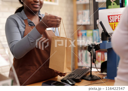 Clerk passing purchase to consumer 116422547