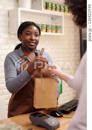 Passing paperbag with skincare products 116422549