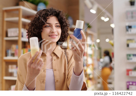 Happy girl choosing makeup remover Happy girl choosing makeup remover 116422742