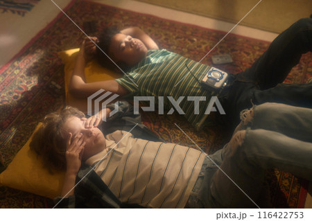 Boys Relaxing on Rug with Vintage Music Player Boys Relaxing on Rug with Vintage Music Player 116422753