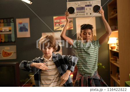 Boys Dancing and Holding Boombox in Cozy Living Room 116422822