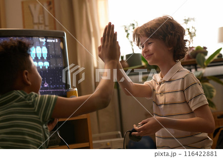 Boys High-Fiving After Winning Video Game Boys High-Fiving After Winning Video Game 116422881