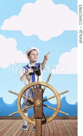 Young boy dressed as sailor standing confidently at ship helm, holding binoculars and pointing ahead. Contemporary art collage. 116423063
