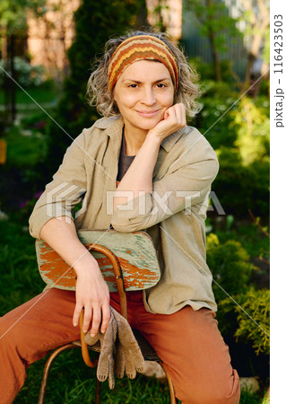 Restful female gardener in workwear Restful female gardener in workwear 116423503