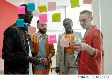 Creative Team Collaborating on Innovative Solutions Creative Team Collaborating on Innovative Solutions 116423793