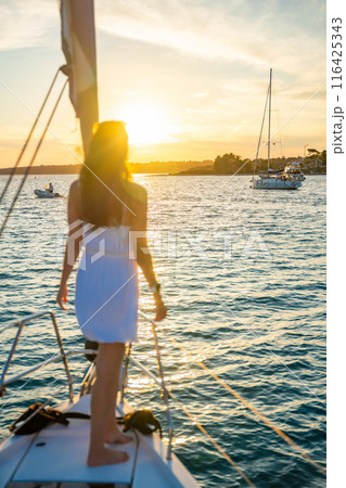 Young woman sailing, young adult lady enjoying summer travel, close-up portrait of female face, summer cruise holidays, European girl tourist traveling in sail boat in Croatia 116425343