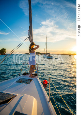 Young woman sailing, young adult lady enjoying summer travel, close-up portrait of female face, summer cruise holidays, European girl tourist traveling in sail boat in Croatia Young woman sailing, young adult lady enjoying summer travel, close-up portrait of female face, summer cruise holidays, European girl tourist traveling in sail boat in Croatia 116425348
